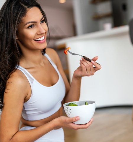 fit-woman-eating-healthy-salad-after-working-out-a-2022-06-15-18-44-52-utc-min.jpg